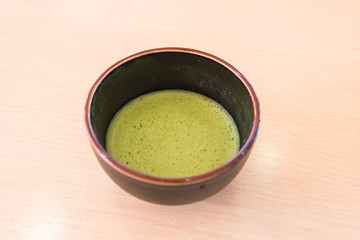 fresh green tea in traditional cup