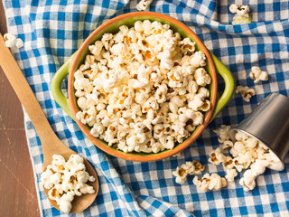 Home made popcorn in a bowl on checkered napkin