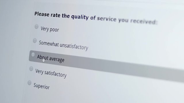 Macro shot of a mouse cursor on a monitor indicating a person giving an unsatisfactory service review on a computer based internet business customer satisfaction survey.