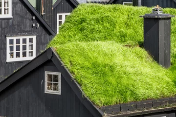 Muurstickers Wooden house with turf roof © EyesTravelling