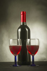 A bottle of wine and a glass