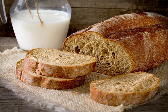 Fresh bread slices and milk in a rustic style