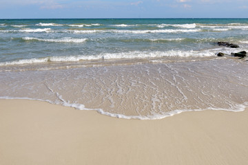 wave of the sea on the sand beach in summer - Apulia, Italy