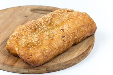 Fresh puff pastry on the wooden board, isolated on white