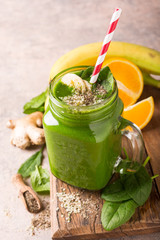 Healthy green smoothie with spinach in glass jar