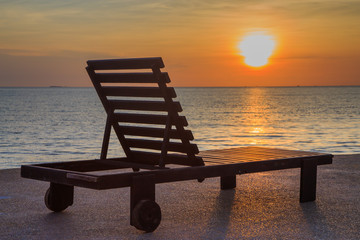 Fototapeta na wymiar Beach chair on beach at sunset