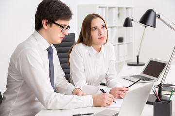 Businessman and businesswoman in office