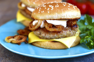 Burger with meat cutlet and caramelized onion.