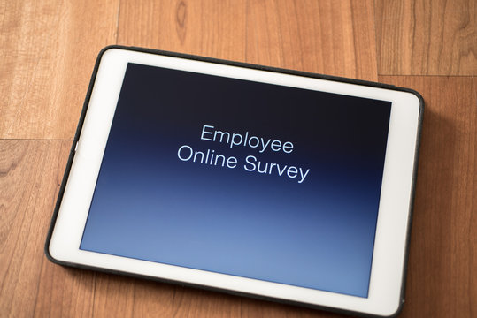 Tablet On Table With Online Employee Survey