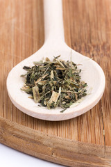 Nettle tea on a wooden spoon