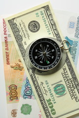 Compass on the background of banknotes