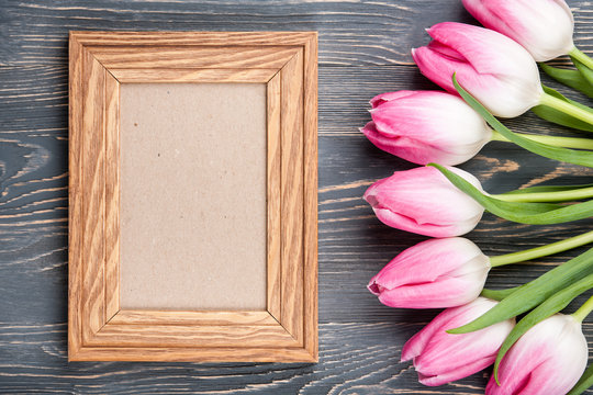 Fresh pink tulips and blank frame