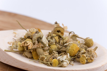 Close macro view of chamomile tea in the spoon