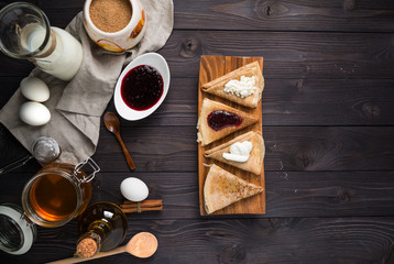 ingredients for baking pancakes on a wooden background