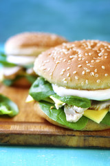 Healthy burger with boiled chicken and baby spinach.