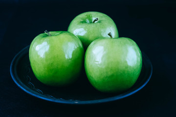 green apples on a black background