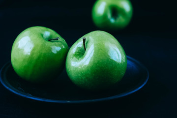 green apples on a black background