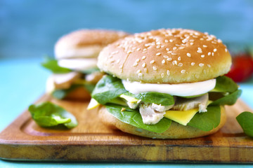 Healthy burger with boiled chicken and baby spinach.