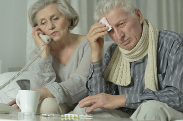 Obraz na płótnie Canvas elderly man and woman with flu