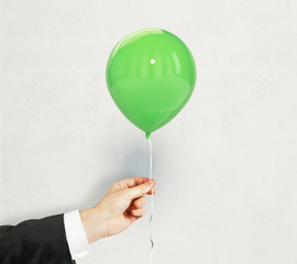 Hand with green balloon