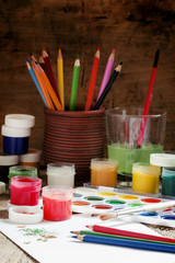Colored pencils and paints - drawing tools, selective focus