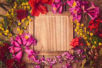 Floral background with wooden board. View from above