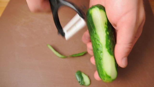 Peeling a cucumber