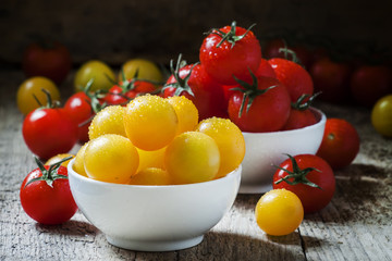 Red and yellow cherry tomatoes in a white porcelain bowl on the