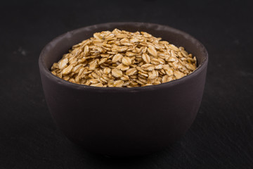oat flakes on a dark stone board