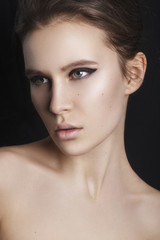 Glamourous closeup female portrait. Fashion evening elegance eyeliner makeup on model eyes. Cosmetics and make-up