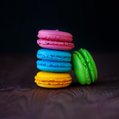 Colorful macaroons tower close-up on black background. 