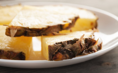 Pineapple sliced pieces on a white plate