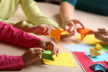 Children making swan with coloured paper