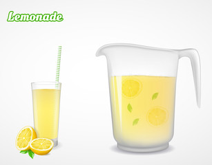 A jug and glass of lemonade and half a lemon with leaf. 