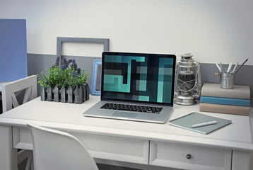 Fototapeta na wymiar Stylish workplace with laptop at home