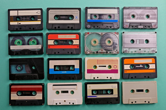 Set of old audio cassettes on turquoise background