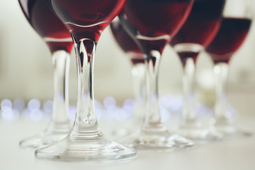 Glasses of red wine on white table closeup
