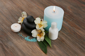 Fototapeta na wymiar Spa still life with light blue candle on wooden background