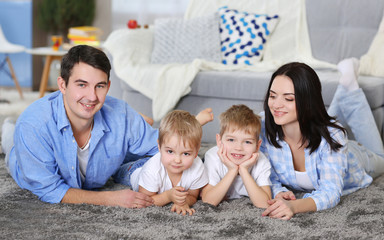 Family concept. Happy family lying on the floor in the room