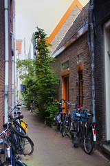 Fototapeta na wymiar Narrow pedestrian street with bicycles in Amsterdam. The Netherlands.