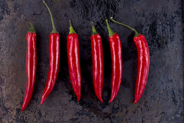 chili peppers on rusty metal background