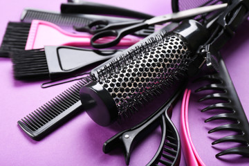 Fototapeta na wymiar Hairdresser set with various accessories on violet background