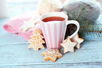 Beautiful winter composition with cup of hot drink, on wooden table