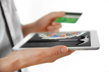 Female hands with digital tablet and credit card, closeup
