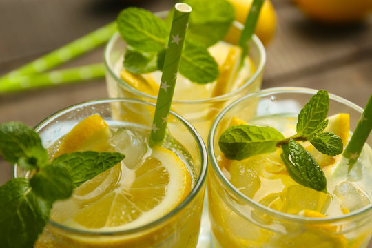 Group of lemonades with lemon and mint view above, closeup