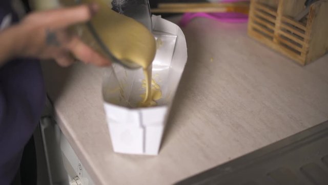Pouring cake batter into baking pan