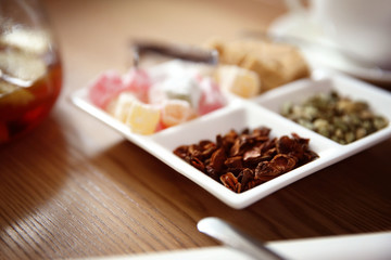 Plate with different sugar and spices on table in cafe or restaurant