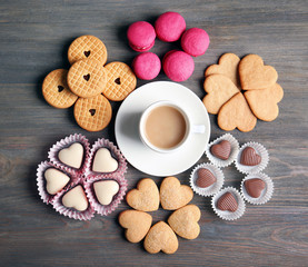 Valentine concept. Composition of cup, cookies and candies on blue background