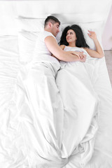 Obraz na płótnie Canvas Lovely couple in white bed