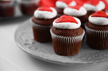 Cupcakes on plate on a light wooden background